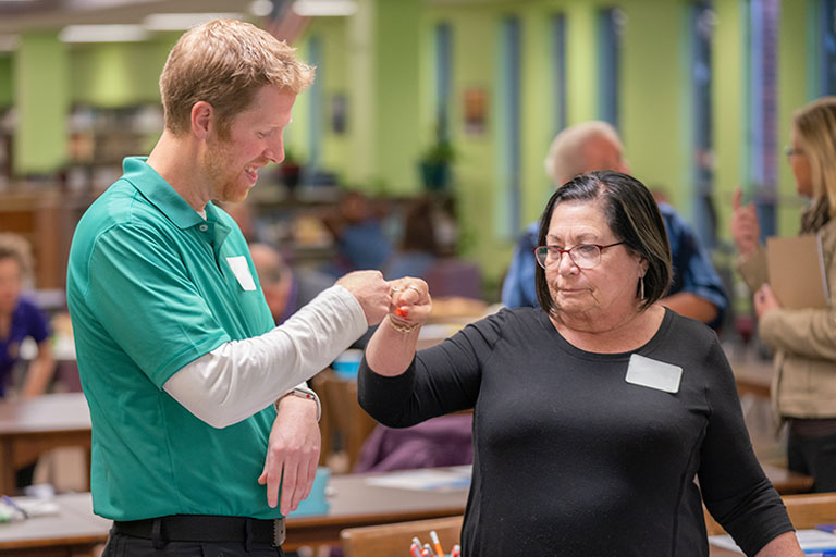 Educators fist bumping